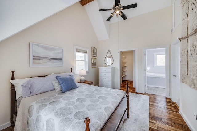 bedroom featuring hardwood / wood-style floors, multiple windows, high vaulted ceiling, a walk in closet, and ceiling fan