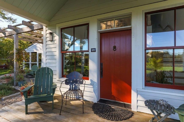 property entrance with a pergola