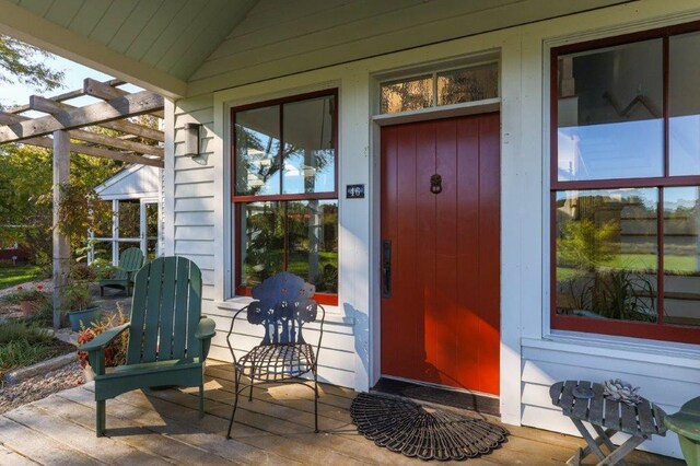 property entrance with a pergola