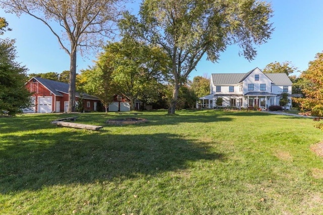 view of yard with a garage and a porch