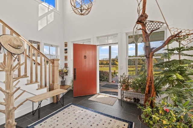 tiled foyer with a high ceiling