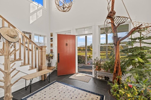 tiled foyer with a high ceiling