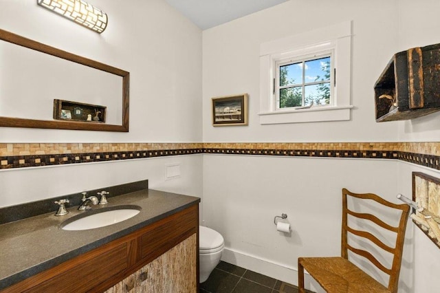 bathroom with vanity, toilet, and tile patterned flooring