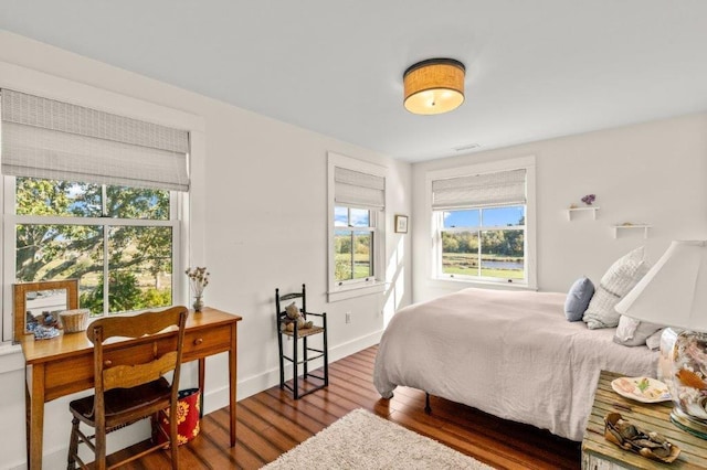 bedroom with dark wood-type flooring