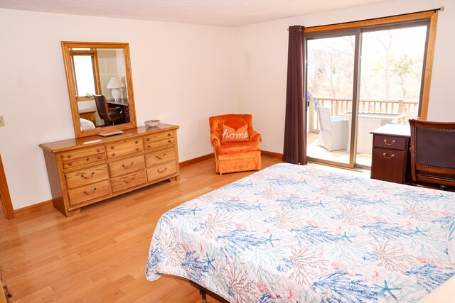 bedroom with baseboards, light wood-style flooring, and access to exterior