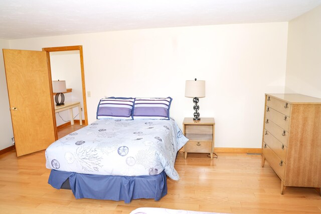 bedroom featuring baseboards and light wood-type flooring