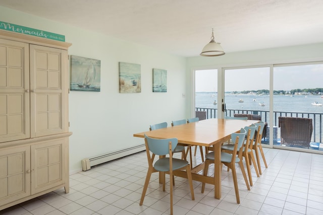 tiled dining area featuring a water view and a baseboard heating unit