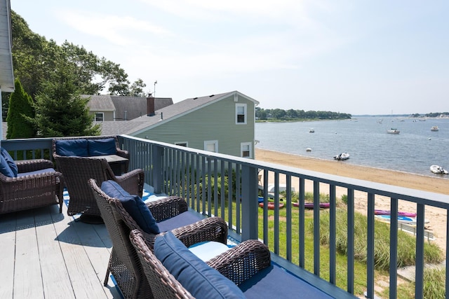 wooden terrace featuring a water view