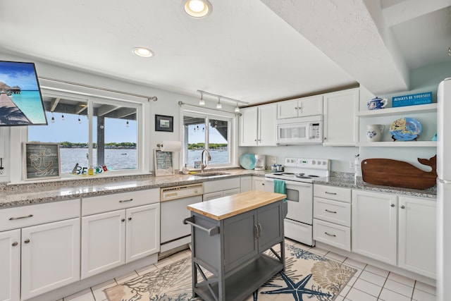 57 Oak St, Wareham, MA 02571 - kitchen with white appliances, a sink, wooden counters, open shelves, and white cabinets