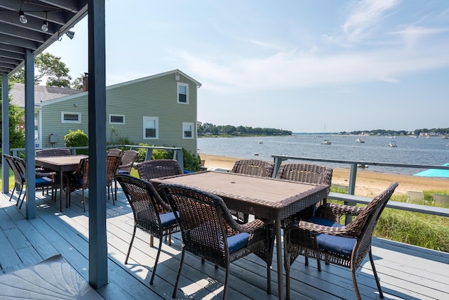 wooden terrace featuring a water view