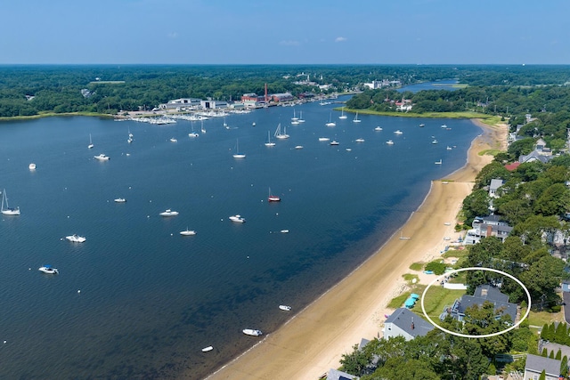 bird's eye view with a water view and a beach view