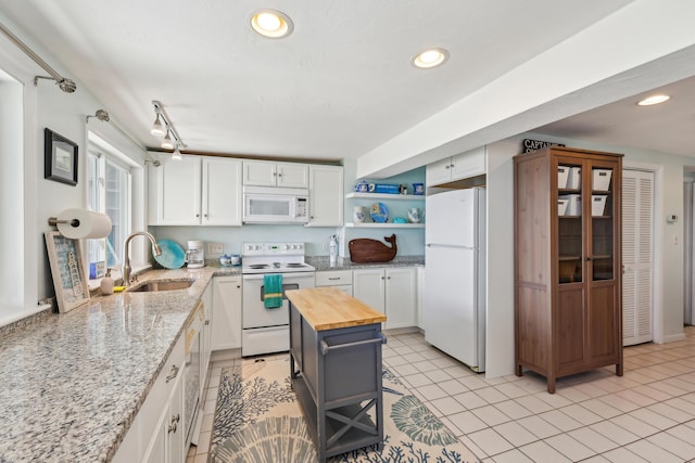 57 Oak St, Wareham, MA 02571 - kitchen with white appliances, a sink, wooden counters, open shelves, and white cabinetry