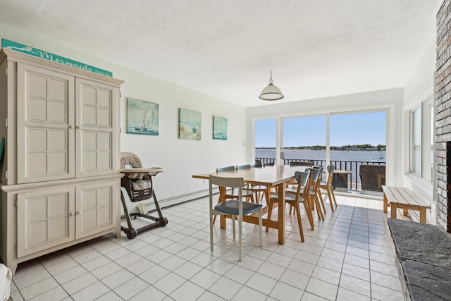 57 Oak St, Wareham, MA 02571 - dining room featuring baseboard heating, light tile patterned floors, a textured ceiling, and a water view