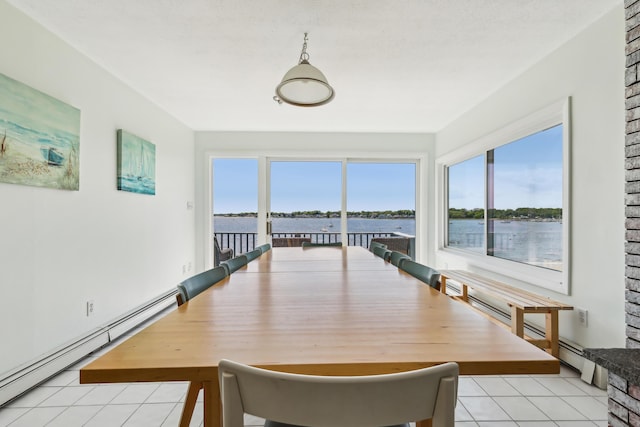 57 Oak St, Wareham, MA 02571 - dining space with light tile patterned floors, a baseboard radiator, and a water view