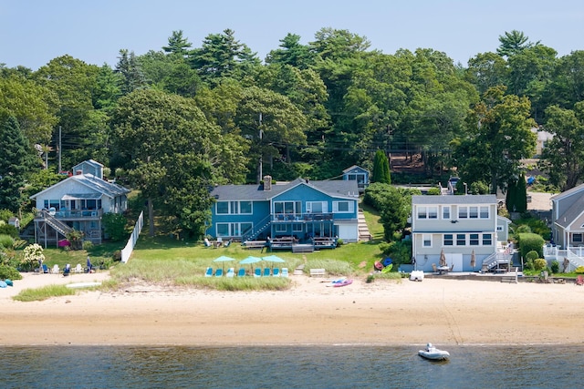 drone / aerial view featuring a beach view and a water view