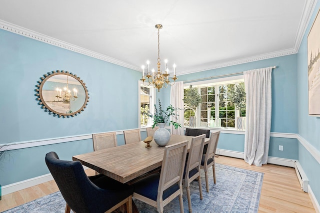 dining room with an inviting chandelier, baseboard heating, ornamental molding, baseboards, and light wood-type flooring