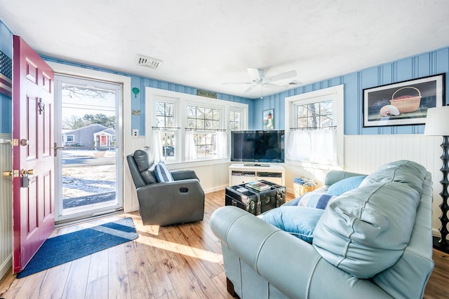 living room featuring ceiling fan and light hardwood / wood-style flooring