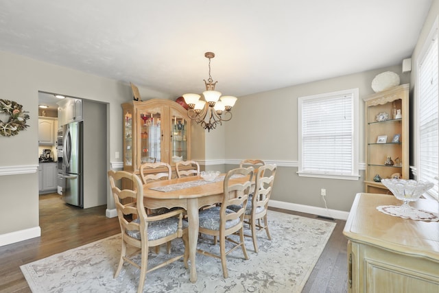 5 Lancaster Ln, Bourne, MA 02532 - dining space featuring dark wood-style flooring, a chandelier, plenty of natural light, and baseboards