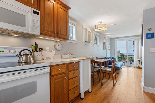 544 Shore Rd Unit 9, Truro, MA 02666 - kitchen with white appliances, brown cabinets, light wood-type flooring, and light countertops