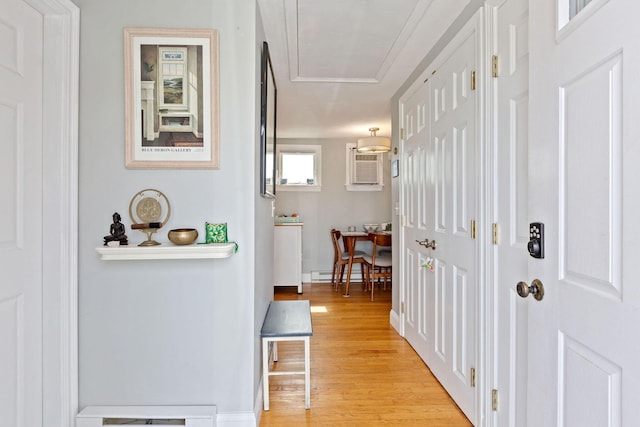 544 Shore Rd Unit 9, Truro, MA 02666 - hall featuring light wood-style flooring, attic access, a wall mounted AC, baseboards, and a baseboard radiator