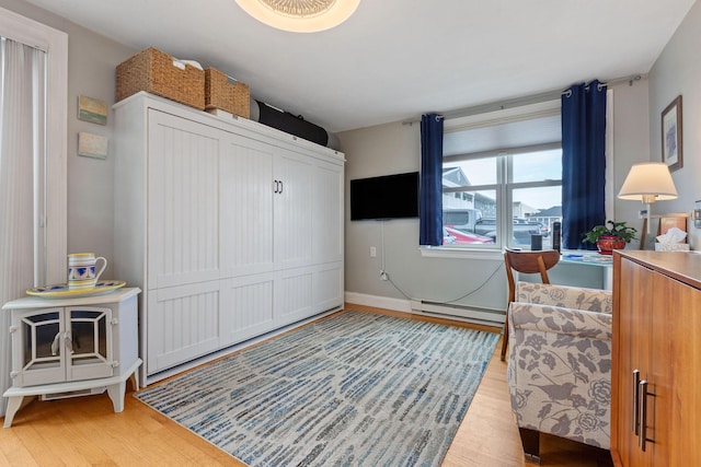 544 Shore Rd Unit 9, Truro, MA 02666 - bedroom featuring wood finished floors, a baseboard heating unit, and baseboards