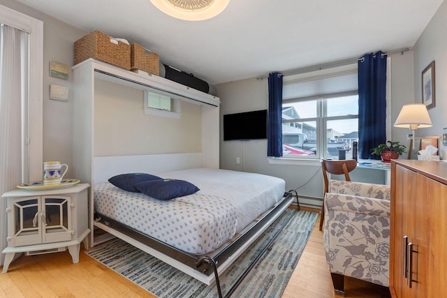 544 Shore Rd Unit 9, Truro, MA 02666 - bedroom with wood finished floors and a baseboard heating unit