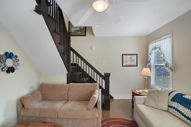 living room featuring ceiling fan and dark hardwood / wood-style floors