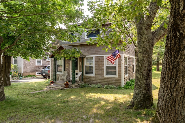 view of property hidden behind natural elements featuring a front yard