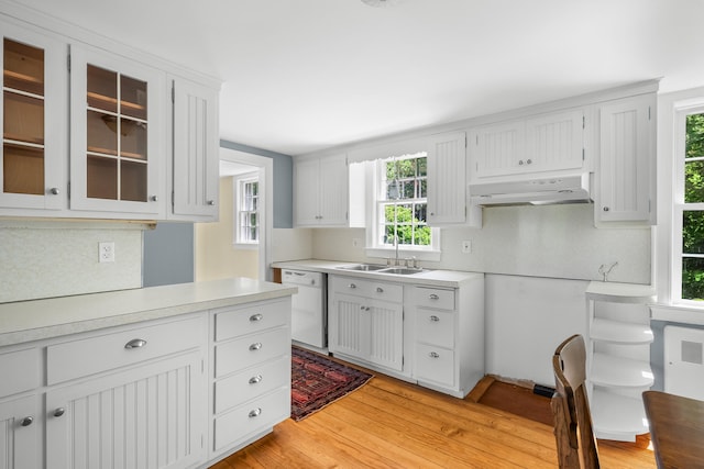 56 Wharf Ln, Yarmouth Port, MA 02675 - kitchen featuring white dishwasher, under cabinet range hood, light countertops, light wood-style floors, and plenty of natural light