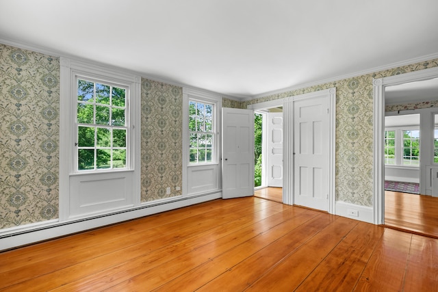 56 Wharf Ln, Yarmouth Port, MA 02675 - entrance foyer with baseboard heating, wallpapered walls, wood finished floors, and crown molding