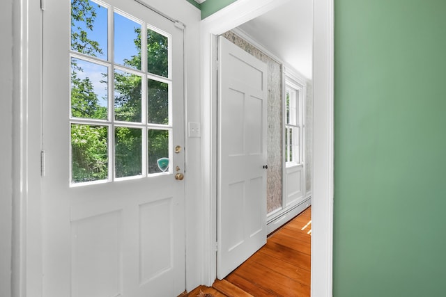 56 Wharf Ln, Yarmouth Port, MA 02675 - doorway to outside with a baseboard radiator and wood finished floors