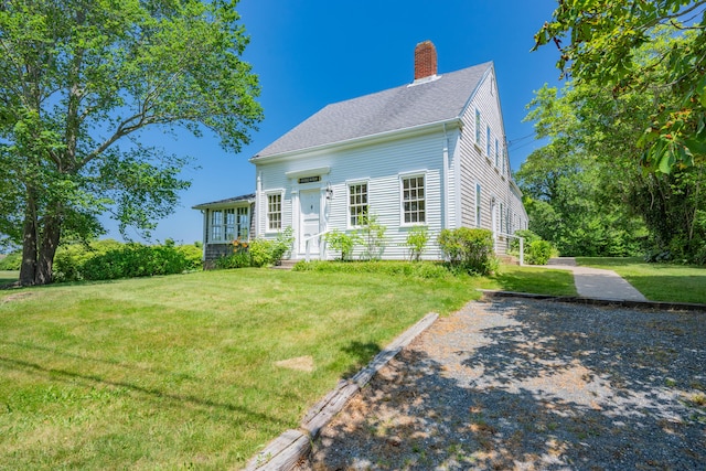 56 Wharf Ln, Yarmouth Port, MA 02675 - view of front of property with a chimney and a front lawn