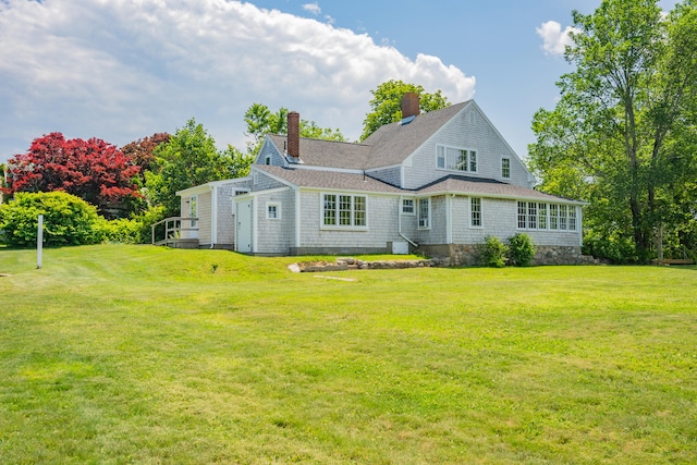 56 Wharf Ln, Yarmouth Port, MA 02675 - rear view of property with a lawn and a chimney