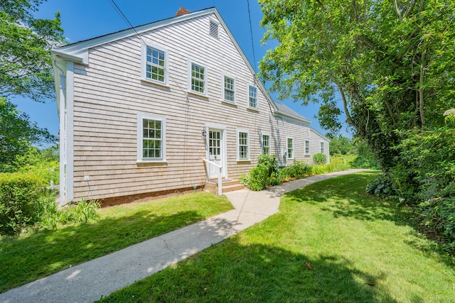 56 Wharf Ln, Yarmouth Port, MA 02675 - view of home's exterior with a lawn