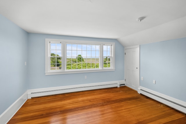 56 Wharf Ln, Yarmouth Port, MA 02675 - spare room with baseboard heating, vaulted ceiling, and wood finished floors