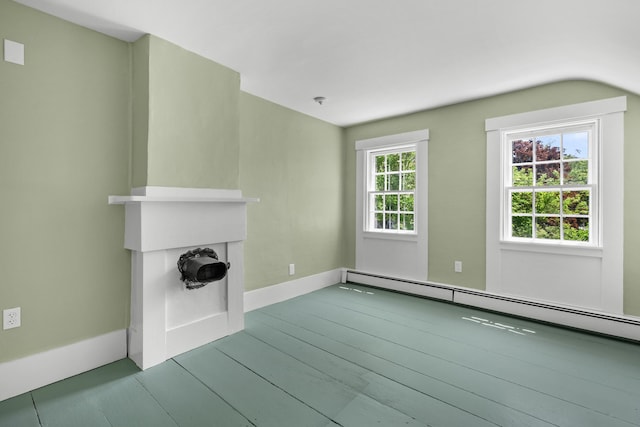 56 Wharf Ln, Yarmouth Port, MA 02675 - unfurnished living room featuring baseboard heating, plenty of natural light, and wood finished floors
