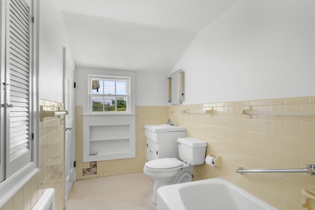 56 Wharf Ln, Yarmouth Port, MA 02675 - bathroom with tile walls, vanity, wainscoting, and a bathtub