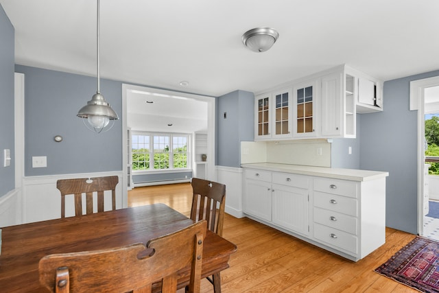 56 Wharf Ln, Yarmouth Port, MA 02675 - dining area featuring light wood-style flooring, healthy amount of natural light, and wainscoting