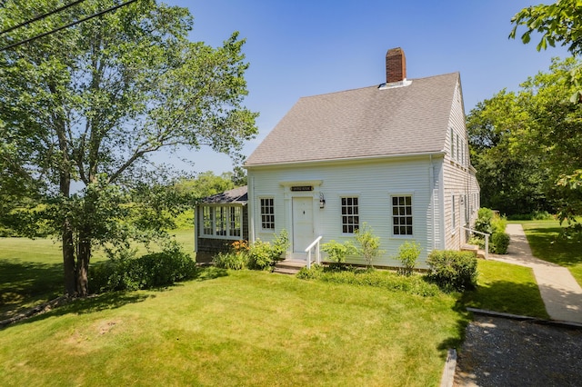 56 Wharf Ln, Yarmouth Port, MA 02675 - view of front of home with a chimney, a front lawn, and a shingled roof