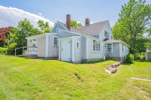 56 Wharf Ln, Yarmouth Port, MA 02675 - rear view of property with a chimney and a lawn