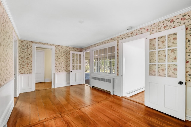 56 Wharf Ln, Yarmouth Port, MA 02675 - empty room with radiator heating unit, wallpapered walls, a baseboard heating unit, hardwood / wood-style flooring, and a wainscoted wall