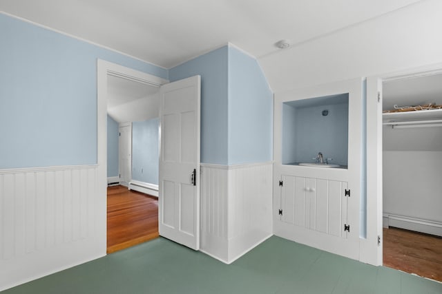56 Wharf Ln, Yarmouth Port, MA 02675 - unfurnished bedroom with baseboard heating, wainscoting, and wood finished floors