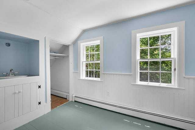 56 Wharf Ln, Yarmouth Port, MA 02675 - unfurnished bedroom featuring a baseboard heating unit, a baseboard radiator, wainscoting, lofted ceiling, and a closet