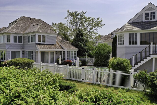 back of house with a fenced backyard