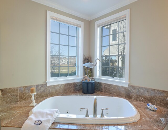 full bathroom with a wealth of natural light, a tub with jets, and crown molding