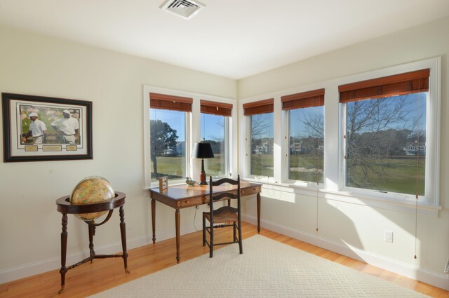 interior space featuring wood finished floors, baseboards, and visible vents