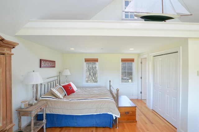 bedroom featuring a closet, wood finished floors, and recessed lighting