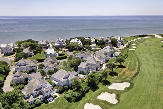 birds eye view of property with golf course view, a water view, and a residential view