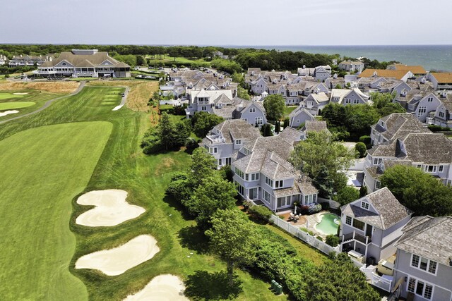 birds eye view of property with view of golf course, a residential view, and a water view