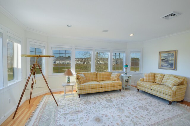 living room with recessed lighting, ornamental molding, baseboards, visible vents, and wood finished floors
